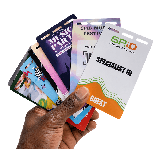 Hands holding a fan of printed event badges and lanyards